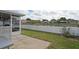 A beautiful view from the screened-in porch, of the white fence and pond view at 13131 Early Run Ln, Riverview, FL 33578