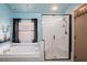 This bathroom features a soaking tub next to a glass enclosed shower with white tiling at 13131 Early Run Ln, Riverview, FL 33578