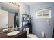 Bathroom featuring a sink, toilet, shower and window for natural lighting at 13131 Early Run Ln, Riverview, FL 33578