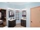 This bathroom features duel vanities and sinks with modern fixtures and wood-look flooring at 13131 Early Run Ln, Riverview, FL 33578