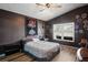 This charming bedroom features wood floors, a Buccaneers tapestry, and an abundance of decor at 13131 Early Run Ln, Riverview, FL 33578