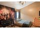 Cozy bedroom featuring a bed, fan lighting, and an Avengers themed wall mural at 13131 Early Run Ln, Riverview, FL 33578