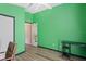 Bedroom with green walls and wood-look floors provides a clean, adaptable space at 13131 Early Run Ln, Riverview, FL 33578