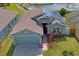 Inviting single-Gathering home featuring a two-car garage, solar panels, and a meticulously maintained lawn near a pond at 13131 Early Run Ln, Riverview, FL 33578