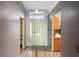 Bright foyer features a light-green front door, wood flooring, and neutral wall paint at 13131 Early Run Ln, Riverview, FL 33578