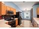 Bright kitchen boasts stainless steel appliances, light wood cabinets, and stylish backsplash at 13131 Early Run Ln, Riverview, FL 33578