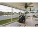 Enjoy outdoor living on this screened lanai with views of the fenced backyard and pond at 13131 Early Run Ln, Riverview, FL 33578
