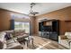 Living room featuring wood floors, comfortable leather seating, and a black entertainment center at 13131 Early Run Ln, Riverview, FL 33578