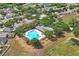 Aerial view of a community pool surrounded by lush trees and manicured landscaping in a neighborhood setting at 13131 Early Run Ln, Riverview, FL 33578