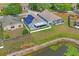 Aerial view of the home's backyard with a screened-in patio, backing onto a pond for serene outdoor living at 13131 Early Run Ln, Riverview, FL 33578