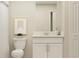 Bright bathroom features a stylish vanity, mirror, and decorative artwork above the toilet at 13511 White Gold Run, Parrish, FL 34219