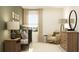 Bright bedroom showcasing a metal crib, rocking chair, and stylish wood dresser with decor at 13511 White Gold Run, Parrish, FL 34219