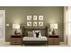 Cozy bedroom with olive green walls, playful animal artwork, and twin nightstands flanking the bed at 13511 White Gold Run, Parrish, FL 34219