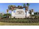 Community entrance sign with lush landscaping, situated along a picturesque lake at 13511 White Gold Run, Parrish, FL 34219