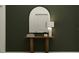 Chic foyer featuring a wooden console table, decorative mirror, and a stylish table lamp at 13511 White Gold Run, Parrish, FL 34219