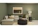 Stylish living room featuring a comfortable sectional sofa, and an accent wall at 13511 White Gold Run, Parrish, FL 34219