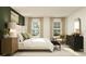 Light-filled main bedroom with a large bed, contemporary furniture, and stylish decor at 13511 White Gold Run, Parrish, FL 34219