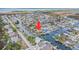 An aerial view of a waterfront neighborhood with water access and multiple houses with pools at 15528 Allmand Dr, Hudson, FL 34667