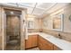 Bathroom with granite countertops, double sinks, decorative seashell accents, and a walk-in shower at 15528 Allmand Dr, Hudson, FL 34667