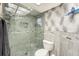 Bathroom with shower featuring mosaic tile accents and glass doors at 15528 Allmand Dr, Hudson, FL 34667