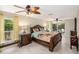 A spacious bedroom featuring decorative lamps, a wooden bed, and lots of natural light at 15528 Allmand Dr, Hudson, FL 34667