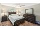 Bedroom with wood bedframe, matching wood dressers, and a large sunny window at 15528 Allmand Dr, Hudson, FL 34667