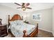 Bedroom with a wood bed frame, a ceiling fan, and a bright window at 15528 Allmand Dr, Hudson, FL 34667