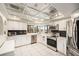 Modern kitchen with white cabinets, stainless steel appliances, and lots of natural light at 15528 Allmand Dr, Hudson, FL 34667