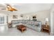 Spacious living room with tile flooring, neutral walls, a gray sofa, and plenty of seating at 15528 Allmand Dr, Hudson, FL 34667