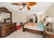 Bright main bedroom featuring ornate wood furnishings and an elegant ceiling fan at 15528 Allmand Dr, Hudson, FL 34667