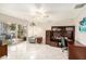 A home office with tile flooring, neutral walls, wooden shelving, and access to a patio at 15528 Allmand Dr, Hudson, FL 34667