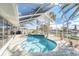 Bright and airy screened pool and patio area featuring a beautiful in-ground pool and a relaxing spa at 15528 Allmand Dr, Hudson, FL 34667