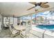 Spacious screened patio offering a poolside dining and lounging area at 15528 Allmand Dr, Hudson, FL 34667
