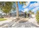 Exterior view of the home's screened patio, surrounded by lush landscaping and a serene atmosphere at 15528 Allmand Dr, Hudson, FL 34667
