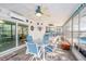 Sunroom with light blue table set and views of the pool at 15528 Allmand Dr, Hudson, FL 34667