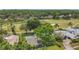 Aerial view of a home with a private pool, near a golf course and lush greenery at 16528 Oley Ridge Ct, Tampa, FL 33624