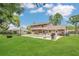 Spacious backyard with pool, patio, and mature trees at 16528 Oley Ridge Ct, Tampa, FL 33624