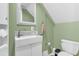 Charming bathroom features decorative mirror, modern vanity, and updated tiling at 16528 Oley Ridge Ct, Tampa, FL 33624