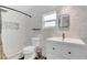Updated bathroom with white marble tiling, shower stall, and modern vanity at 16528 Oley Ridge Ct, Tampa, FL 33624