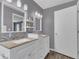 Bathroom showcasing double sink vanity, granite countertops, and updated fixtures at 16528 Oley Ridge Ct, Tampa, FL 33624