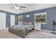 The Main Bedroom features two large windows, neutral carpet, and a ceiling fan at 16528 Oley Ridge Ct, Tampa, FL 33624