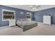 The Main Bedroom features two large windows, neutral carpet, and a ceiling fan at 16528 Oley Ridge Ct, Tampa, FL 33624