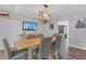 The dining room area features wood floors, and a rectangular table with six chairs at 16528 Oley Ridge Ct, Tampa, FL 33624
