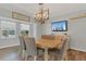 Well-lit dining room features a dining table with chairs, window and modern light fixture at 16528 Oley Ridge Ct, Tampa, FL 33624