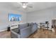 Living room featuring wood floors, large television, and recessed lighting at 16528 Oley Ridge Ct, Tampa, FL 33624