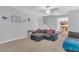 Comfortable living room features gray sectional sofa, stairs and view of the kitchen at 16528 Oley Ridge Ct, Tampa, FL 33624
