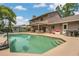 Backyard pool, covered patio and outdoor kitchen create an ideal entertainment space at 16528 Oley Ridge Ct, Tampa, FL 33624