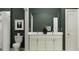 A full bathroom featuring double sinks, a mirror, toilet, and shower at 18148 Serene Lake Loop, Lutz, FL 33548