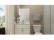 Bathroom with toilet, sink, shower, and window, all with neutral tones at 18148 Serene Lake Loop, Lutz, FL 33548