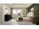 Comfortable primary bedroom with a decorative dresser and sitting area bathed in natural light from large windows at 18148 Serene Lake Loop, Lutz, FL 33548